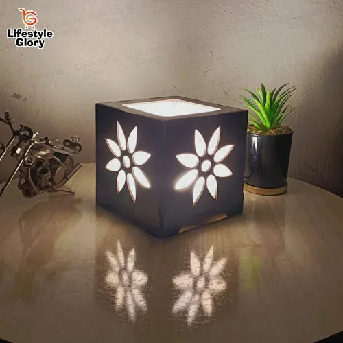 3D wooden table lamp with floral cut-out on glass table